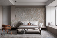 Vintage Floral Artwork wallpaper mural in grey and beige above an upholstered bed in a bedroom