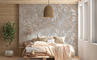Vintage Floral Artwork wallpaper mural with grey leaf outlines above a bed with peach bedding