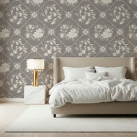 Soft distressed floral tiles wallpaper in bedroom, calm backdrop behind headboard and light bedding