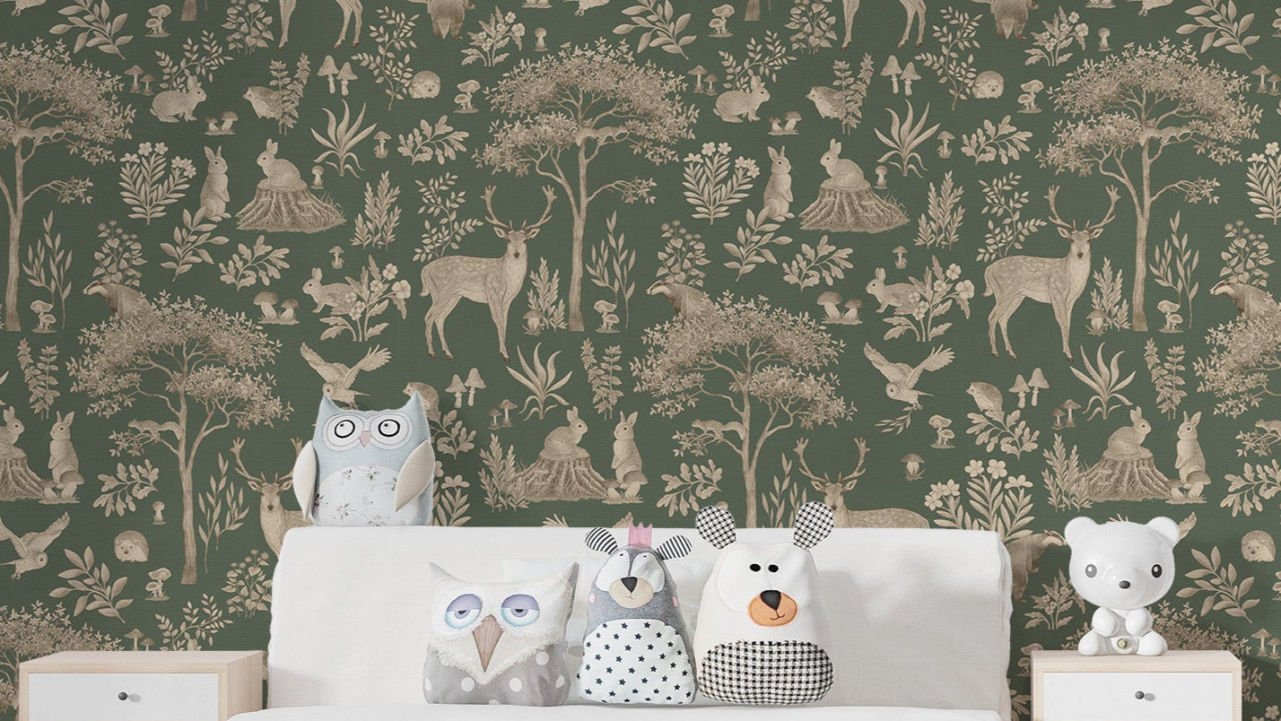 Vintage Green Wildlife wallpaper behind a white bed with owl and bear plush cushions in a kids bedroom