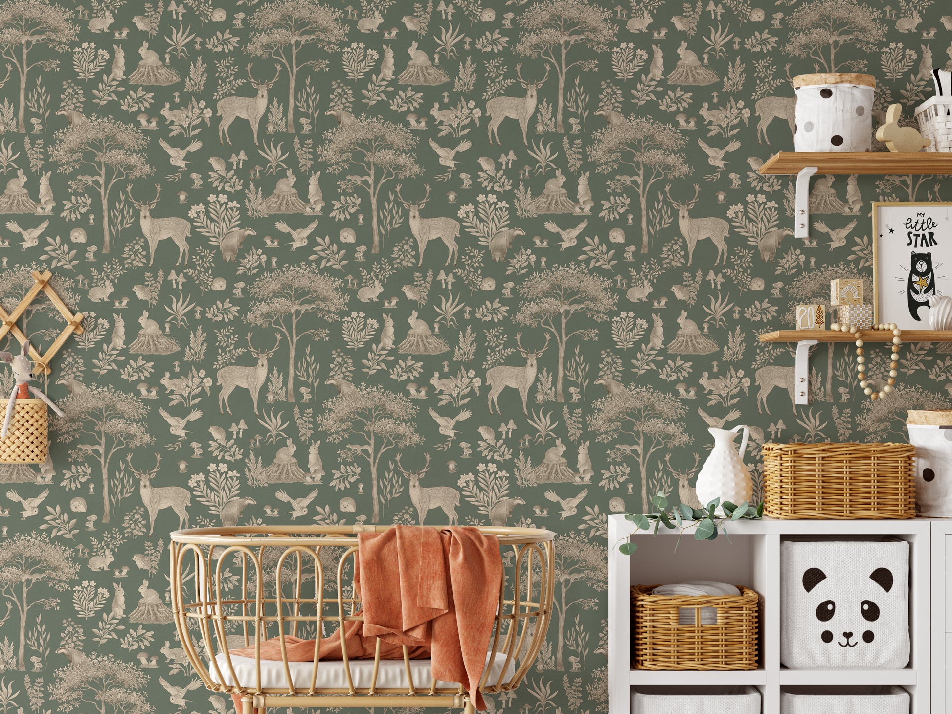 Vintage Green Wildlife wallpaper behind a rattan basket crib with a rust throw and panda basket shelf