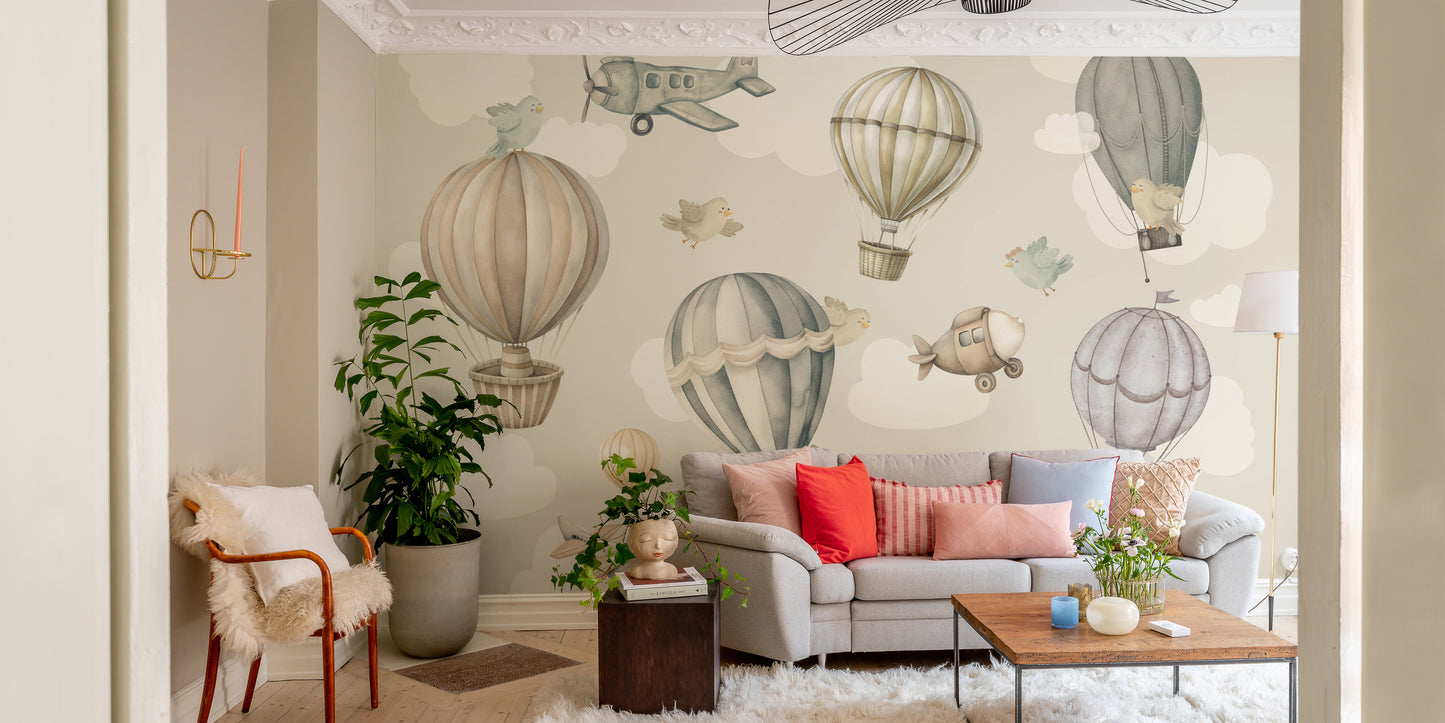 Vintage Hot Air Balloon Nursery wallpaper mural with balloons over a grey sofa and red and pink pillows