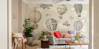 Vintage Hot Air Balloon Nursery wallpaper mural with balloons over a grey sofa and red and pink pillows