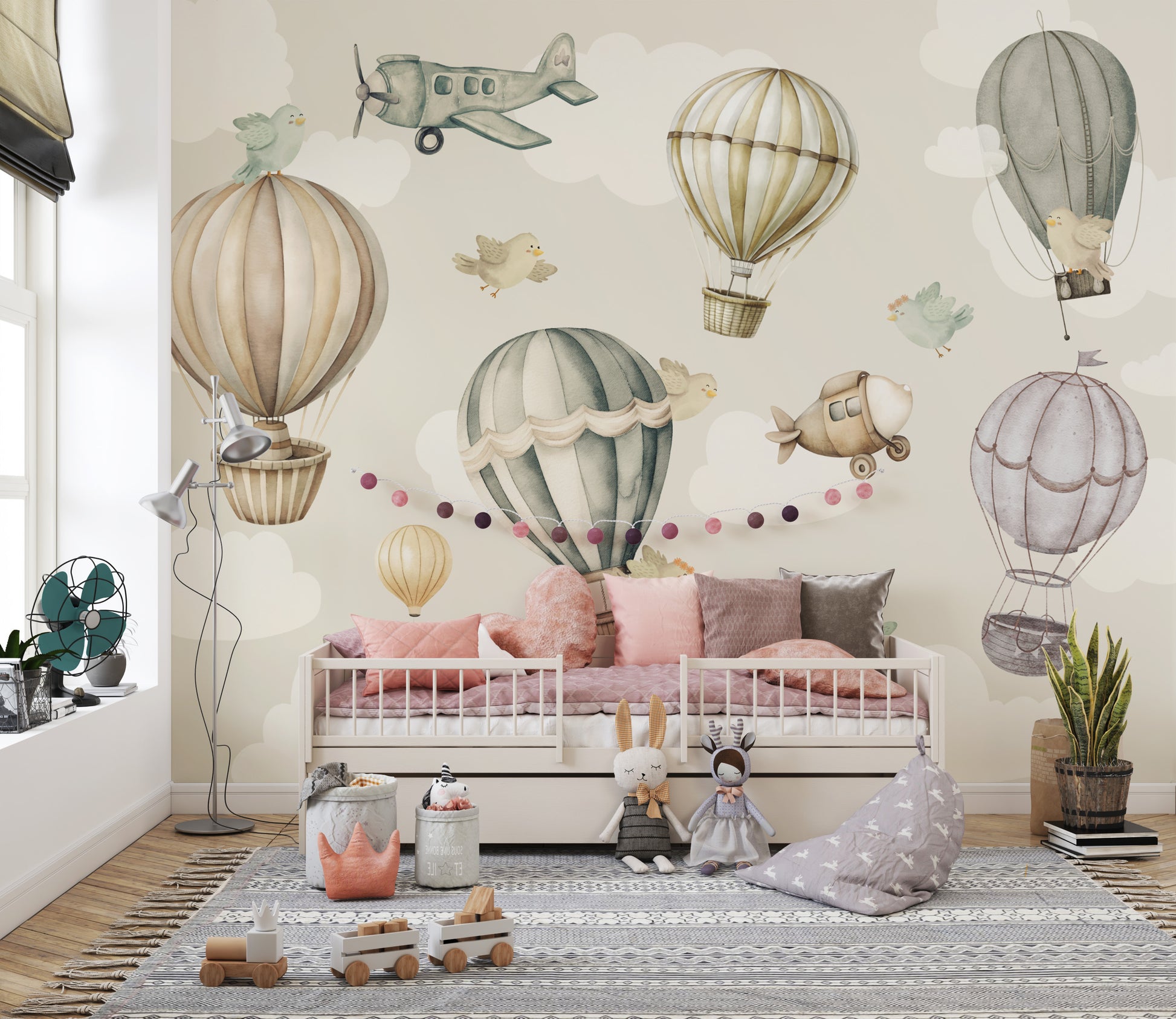 Vintage Hot Air Balloon Nursery wallpaper mural with balloons and birds over a white daybed and pink cushions