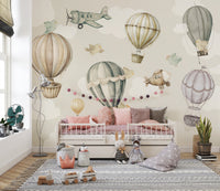 Vintage Hot Air Balloon Nursery wallpaper mural with balloons and birds over a white daybed and pink cushions