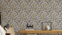 Vintage Foliage Golden and Gray wallpaper behind a wooden console with caned chair and books