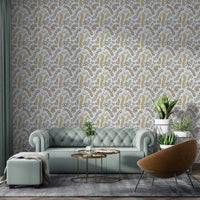 Vintage Foliage Golden and Gray wallpaper behind a sage green sofa and leather armchair in a living room