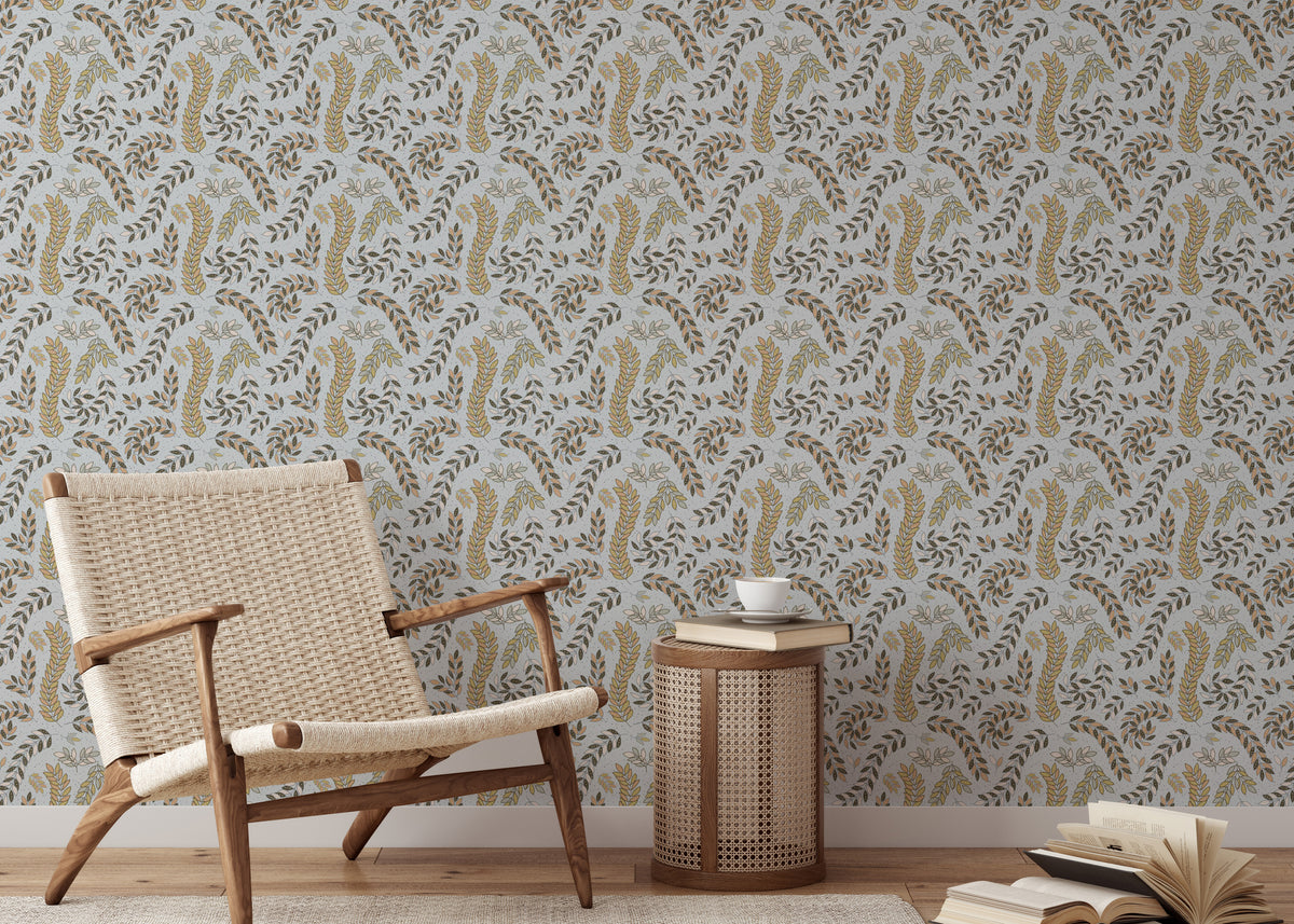 Vintage Foliage Golden and Gray wallpaper behind a woven rattan armchair and caned side table
