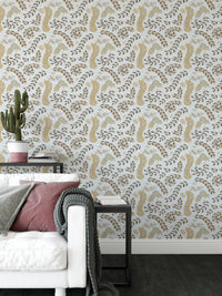 Vintage Foliage Golden and Gray wallpaper behind a white sofa with mauve cushion and cactus in a living room