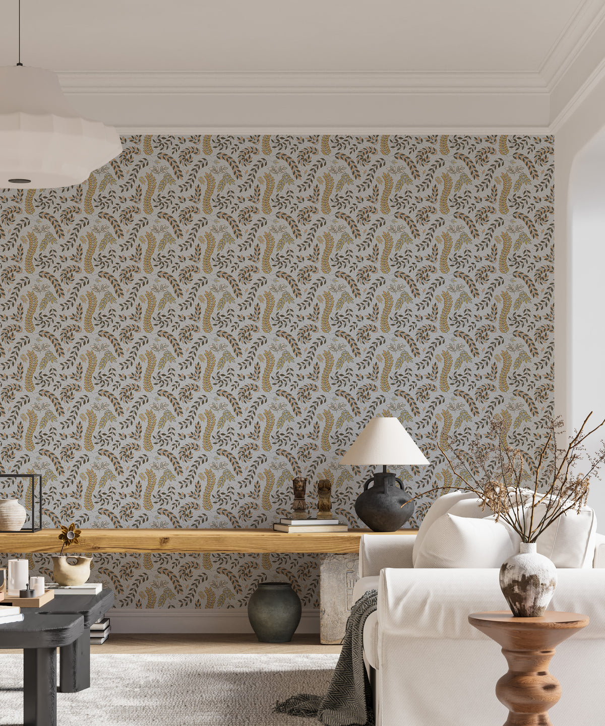 Vintage Foliage Golden and Gray wallpaper behind a white sofa and wooden bench in a bright living room