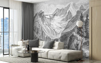 Vintage Mountain wallpaper mural of etched alpine peaks behind a cream sofa with grey pillows in a living room