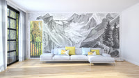 Vintage Mountain wallpaper mural in grey engraving style behind a light grey sofa in a sunny living room