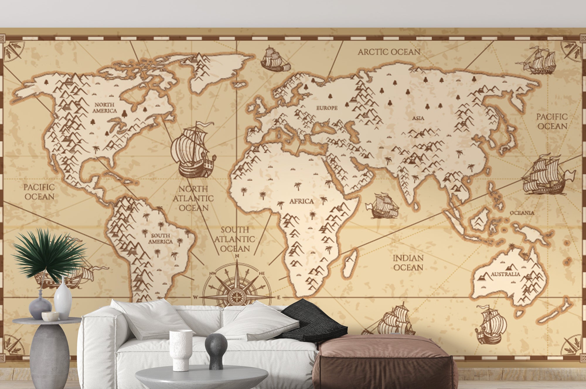Vintage World Map wallpaper in sepia with sailing ships above a white sofa in a bright living room