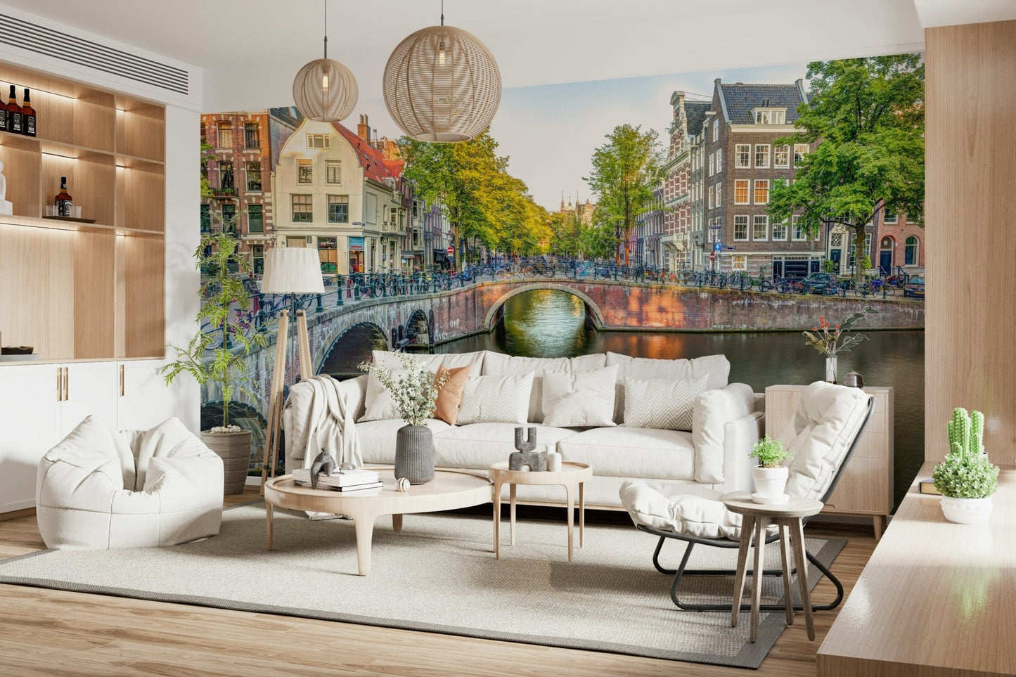 Visit Amsterdam wallpaper mural of an Amsterdam canal behind a white sofa with woven pendant lamps in a living room