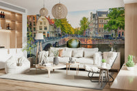 Visit Amsterdam wallpaper mural of an Amsterdam canal behind a white sofa with woven pendant lamps in a living room