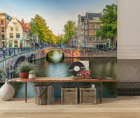 Visit Amsterdam wallpaper mural of canal houses above a wood bench with woven baskets in an entryway
