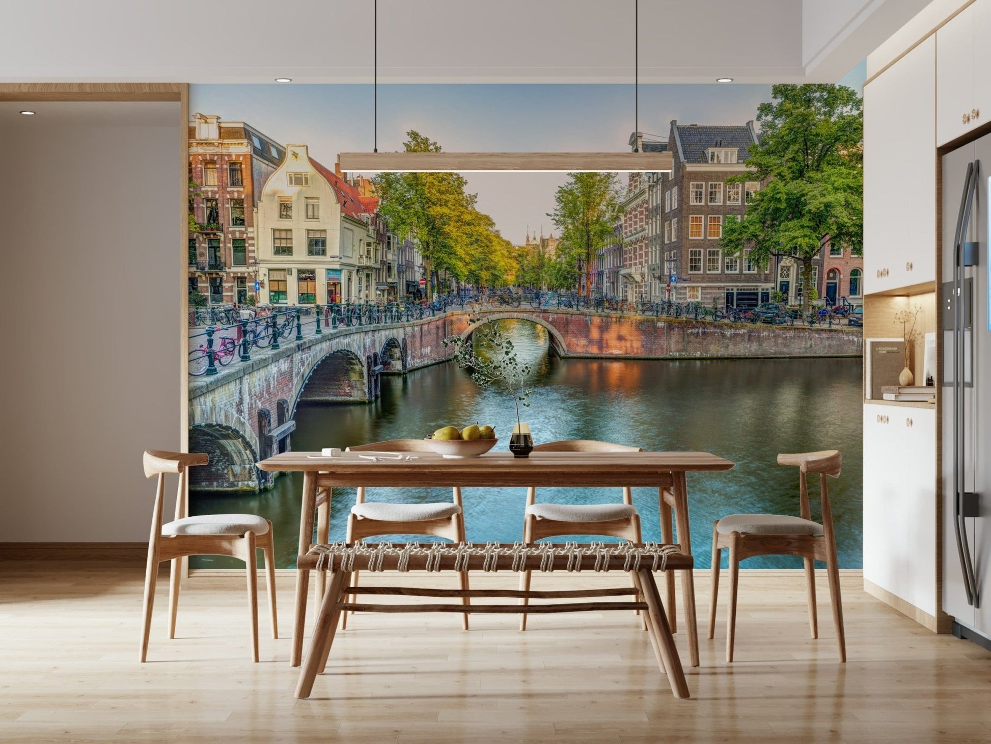 Visit Amsterdam wallpaper mural of a canal bridge behind a walnut dining table with a woven bench in a dining room