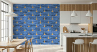 Water-inspired wallpaper with rhythmic black strokes and repeating gold abstract elements.