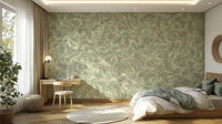 Watercolor Dancing Green Leaf wallpaper mural as a bedroom feature wall behind a bed and wooden desk by a window