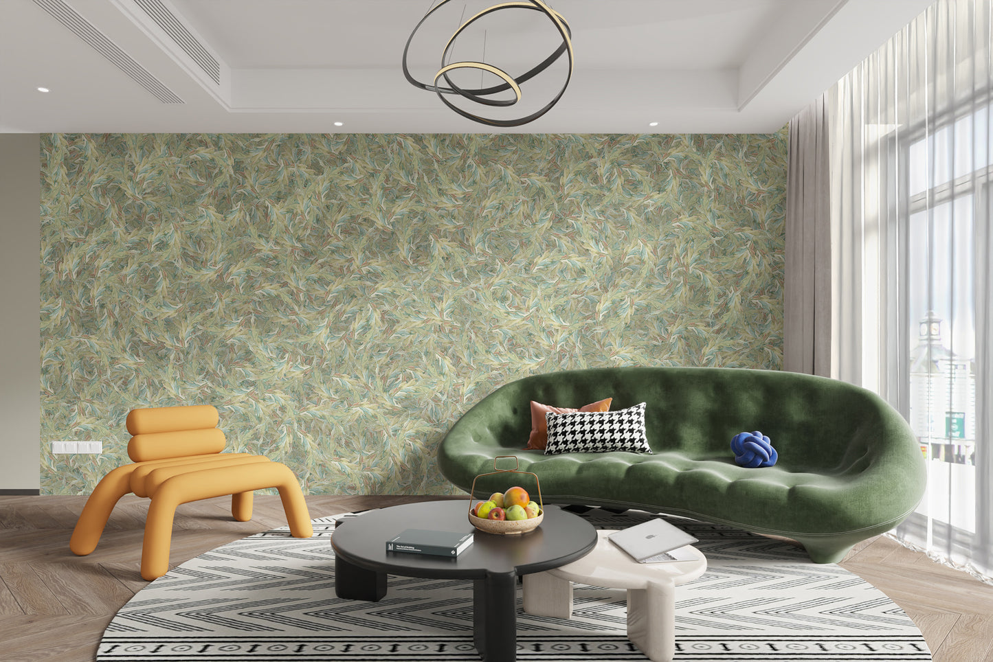 Watercolor Dancing Green Leaf wallpaper mural behind a curved green velvet sofa and orange chair in a living room