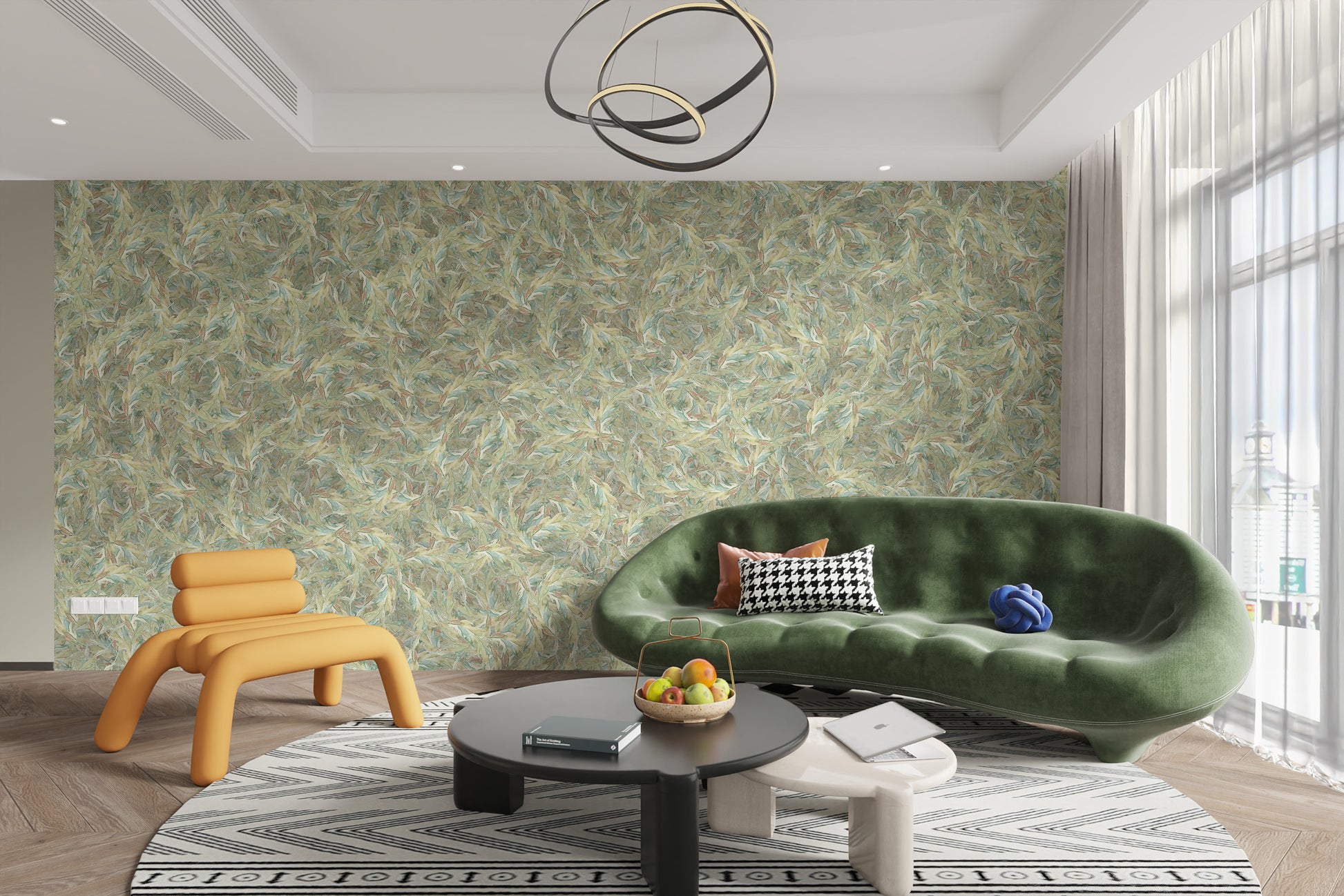 Watercolor Dancing Green Leaf wallpaper mural behind a curved green velvet sofa and orange chair in a living room