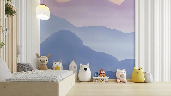 Watercolor Mountains in Pastel Colors mural above a wood kids bed lined with plush animal toys in a nursery