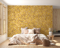 Watercolor Yellow Leaves wallpaper mural behind a bed with neutral bedding in a sunlit bedroom
