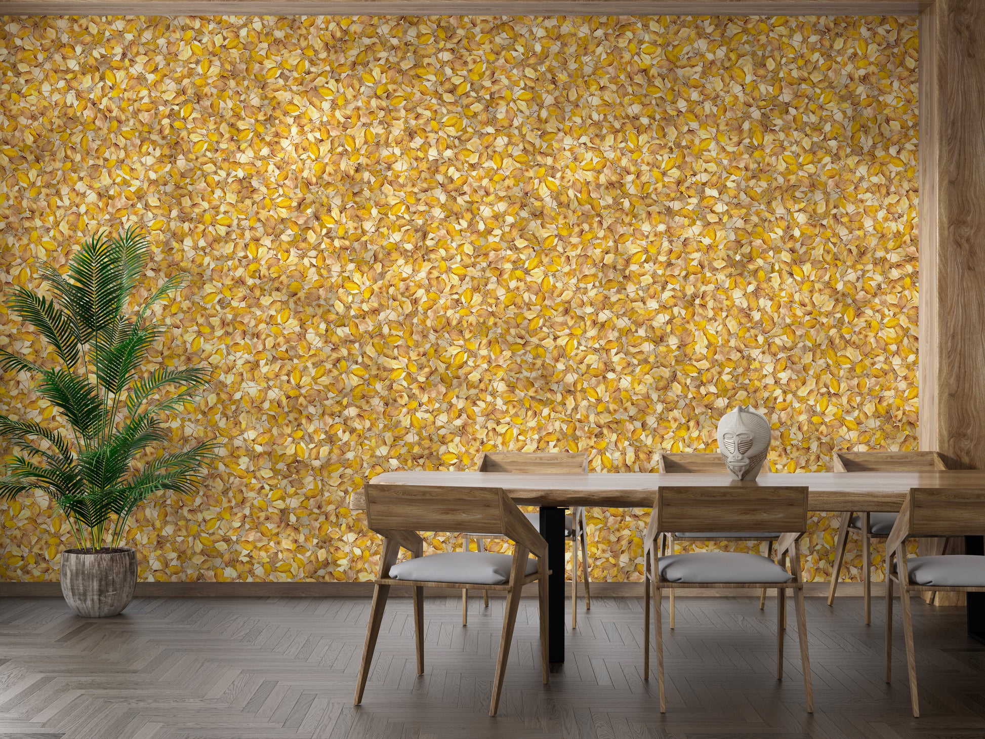 Watercolor Yellow Leaves wallpaper mural behind a wood dining table and chairs with a tall palm plant