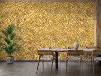 Watercolor Yellow Leaves wallpaper mural behind a wood dining table and chairs with a tall palm plant