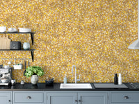 Watercolor Yellow Leaves wallpaper mural above grey kitchen cabinets and a sink with espresso machine