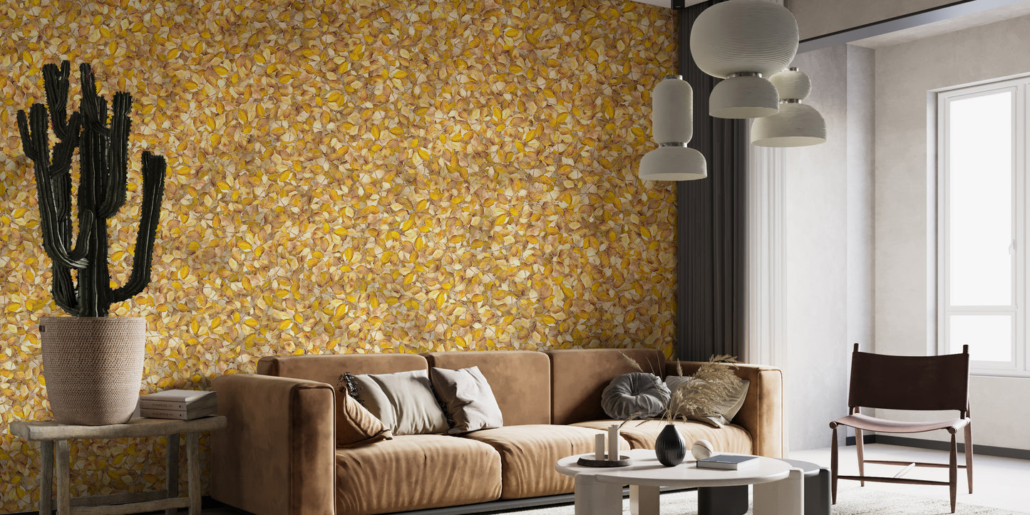 Watercolor Yellow Leaves wallpaper mural behind a camel sofa and black cactus in a bright living room