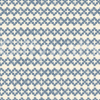 Tactile detail of blue zellige crosses set on a cream wallpaper ground