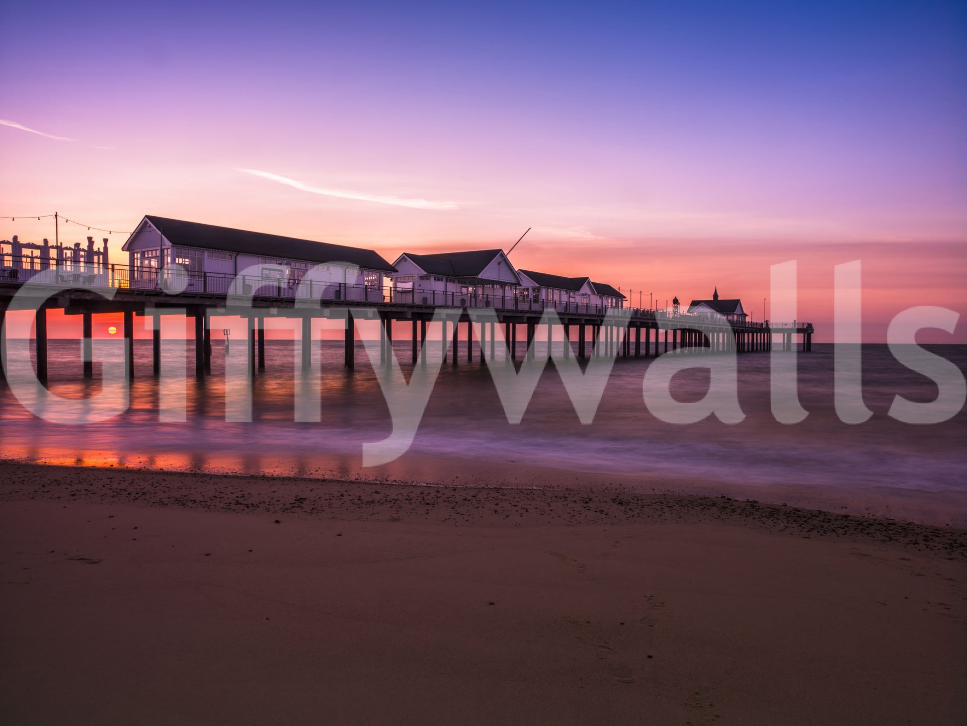The pier stretches in soft silhouette on this Sunset Reverie wall mural.