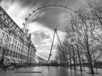 A sky shines through the London Eye Monochrome Majesty wall mural structure.