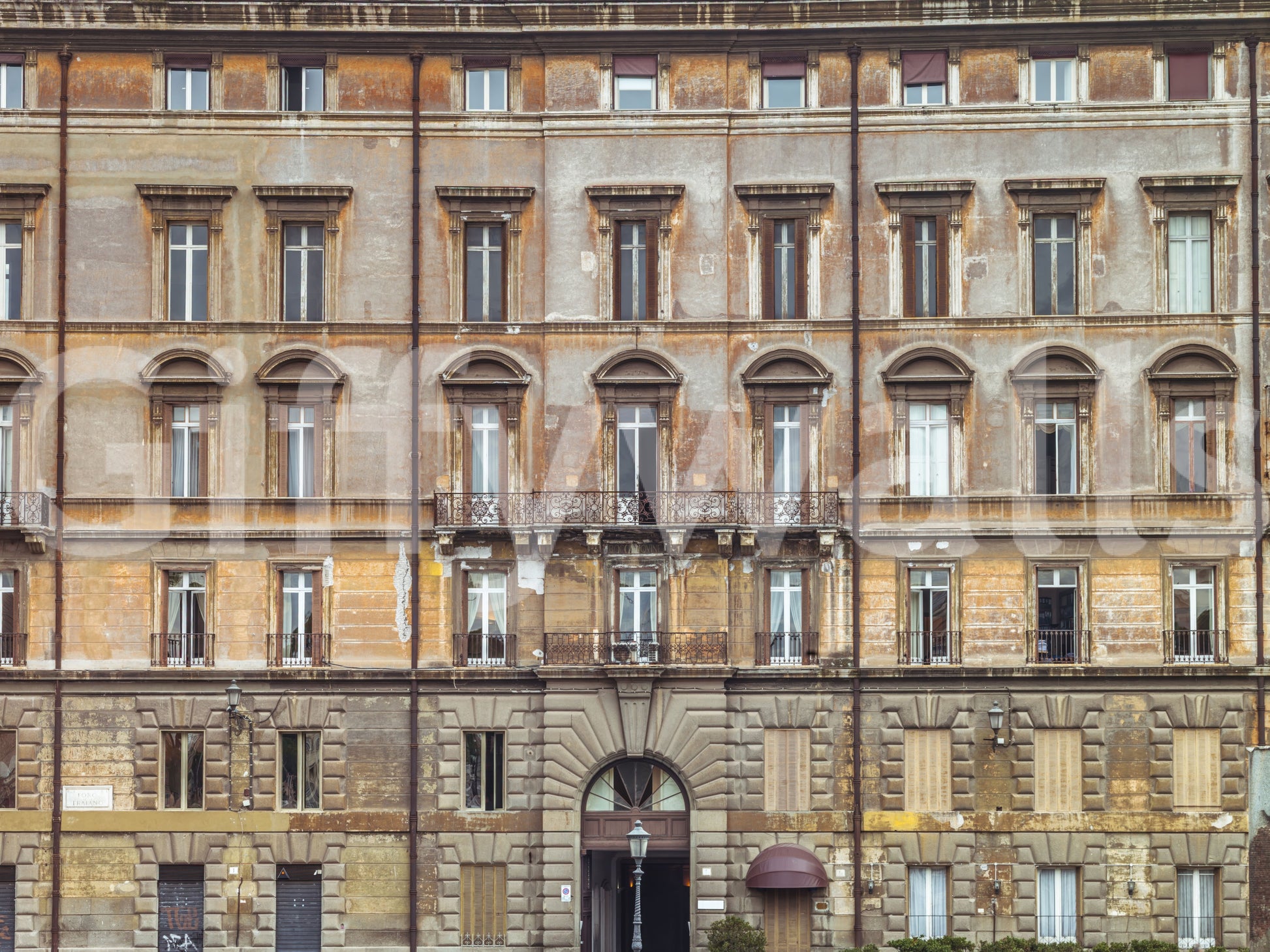 Worn ochre stucco and shutters give this European wall mural a lived-in feel.