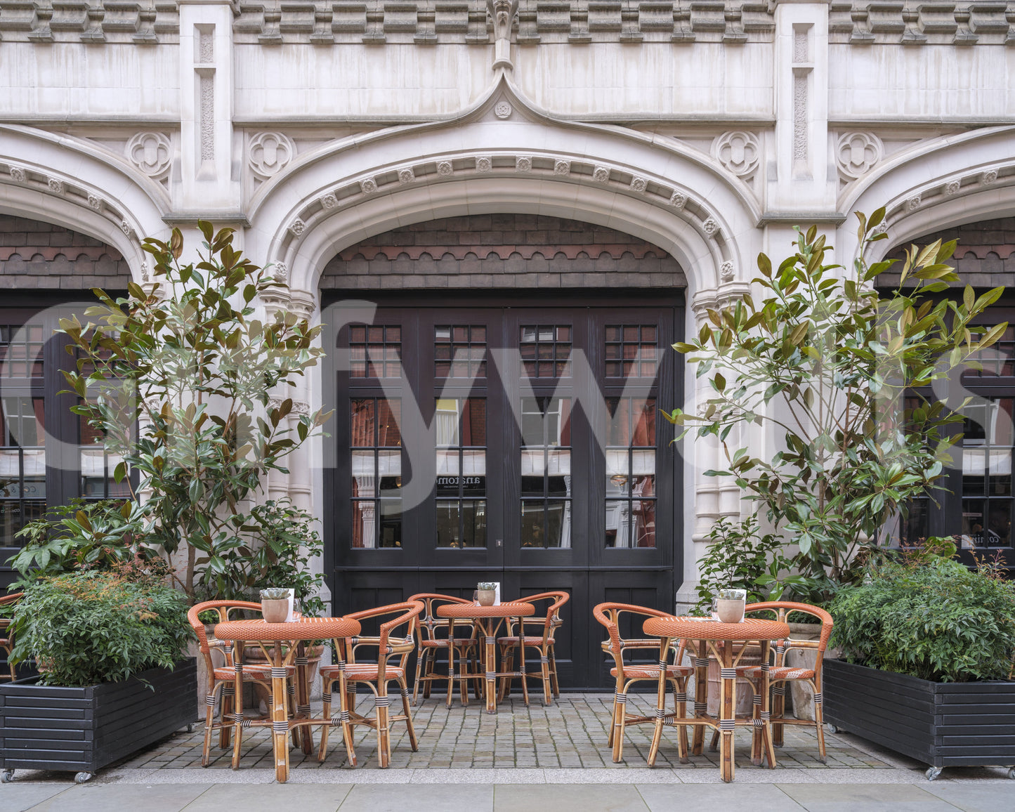 Urban cafe wall mural with welcoming cobblestone street view