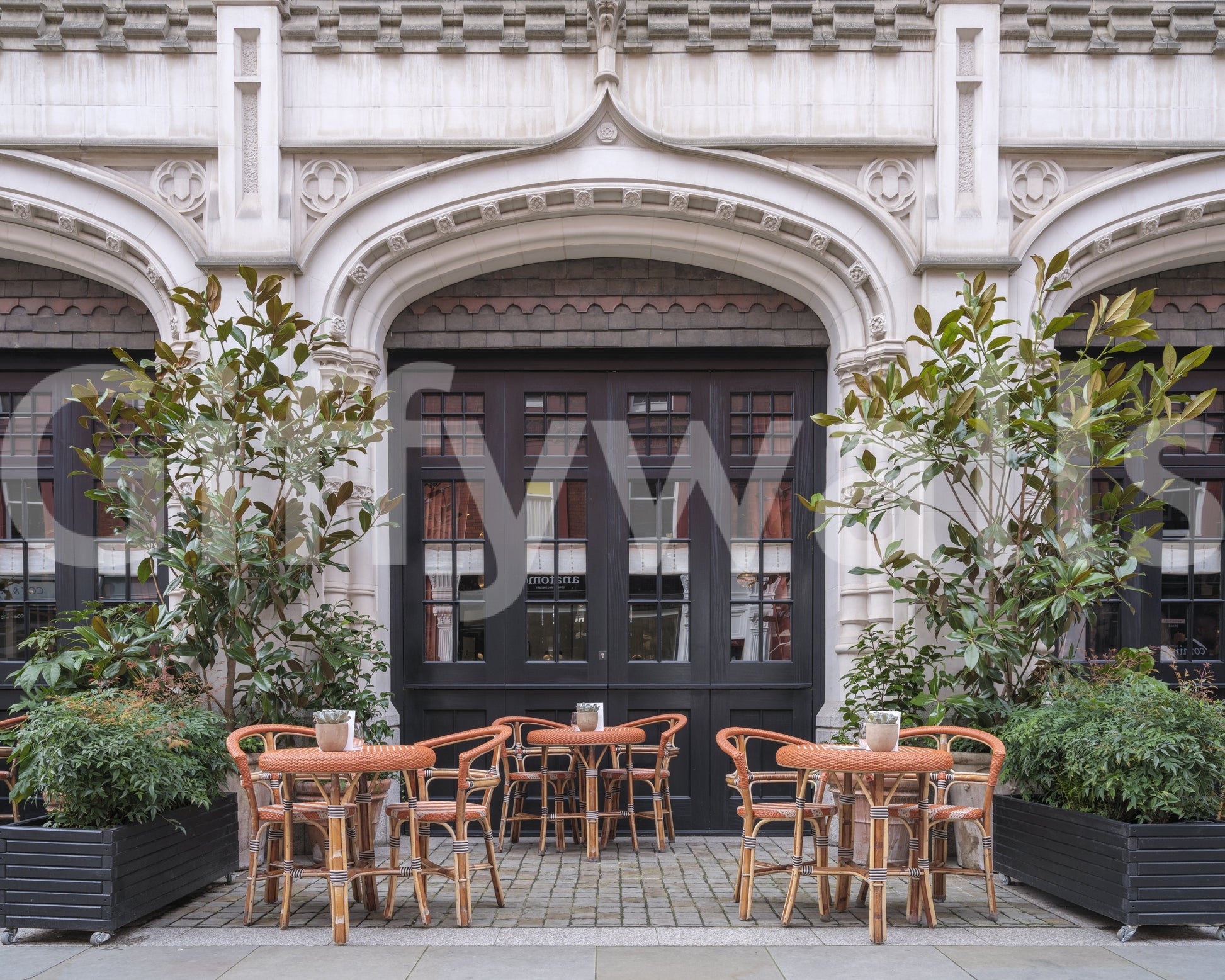 Urban cafe wall mural with welcoming cobblestone street view