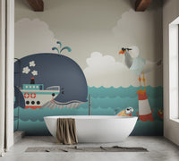 Whale & Steamer Kids wallpaper mural styled as a living room feature wall behind a sofa and seating in blue tones