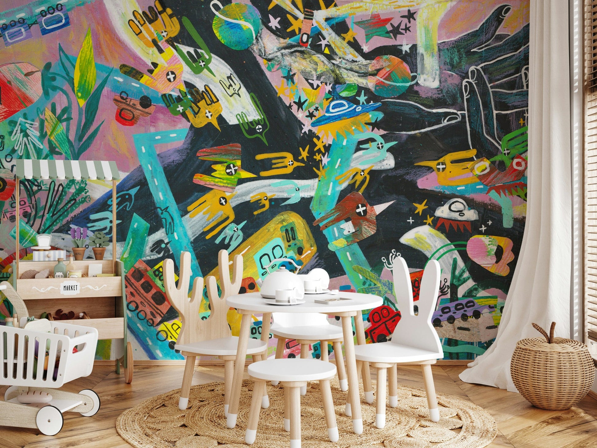 Urban Sprawl Symphony wallpaper mural of a colorful cityscape in a kids playroom with bunny-ear chairs and a toy market cart