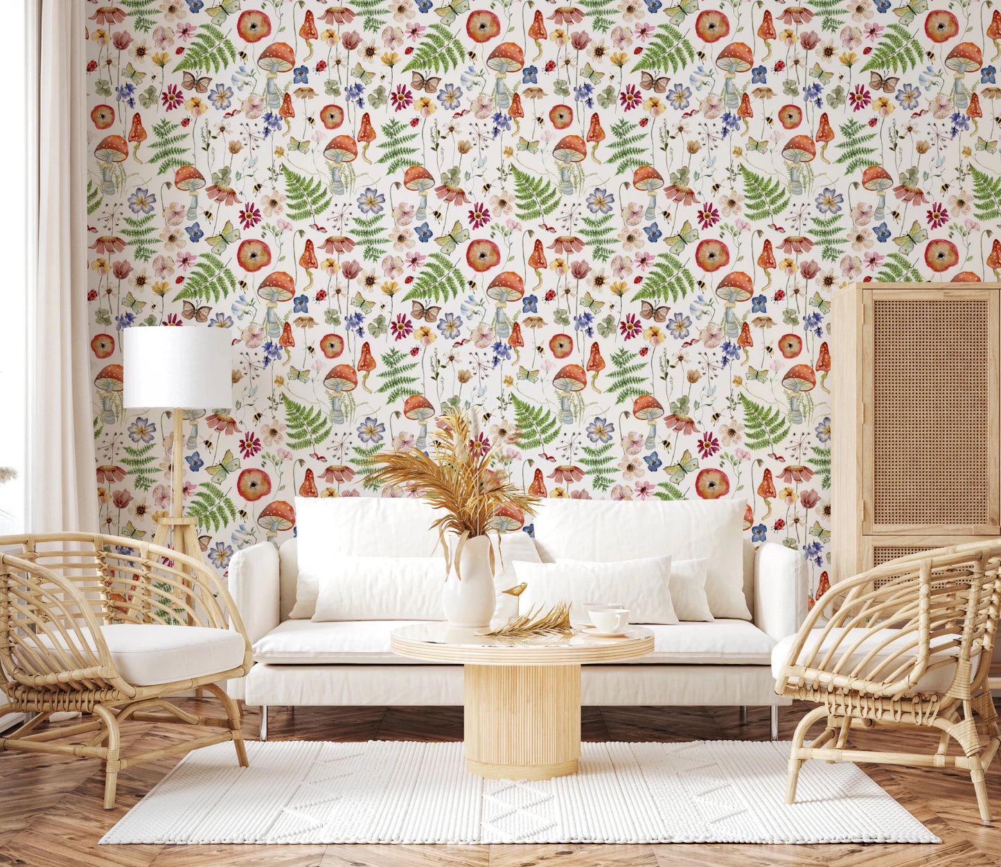 Whimsical Watercolor Meadow wallpaper mural in a living room with a white sofa, rattan armchairs and pampas grass