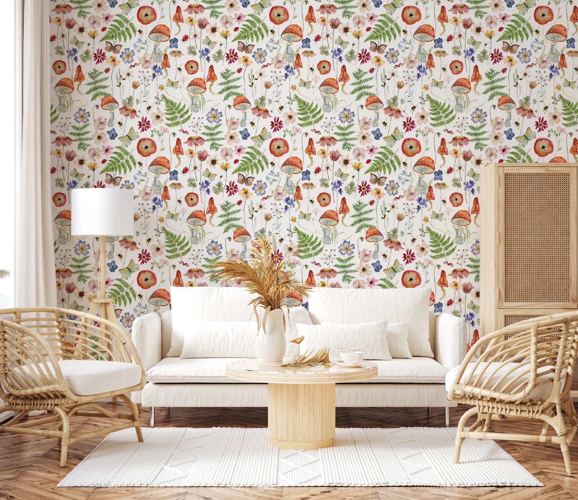 Whimsical Watercolor Meadow wallpaper mural in a living room with a white sofa, rattan armchairs and pampas grass