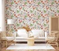 Whimsical Watercolor Meadow wallpaper mural in a living room with a white sofa, rattan armchairs and pampas grass