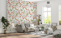 Whimsical Watercolor Meadow wallpaper mural in a living room with a grey sofa, striped cushions and round table