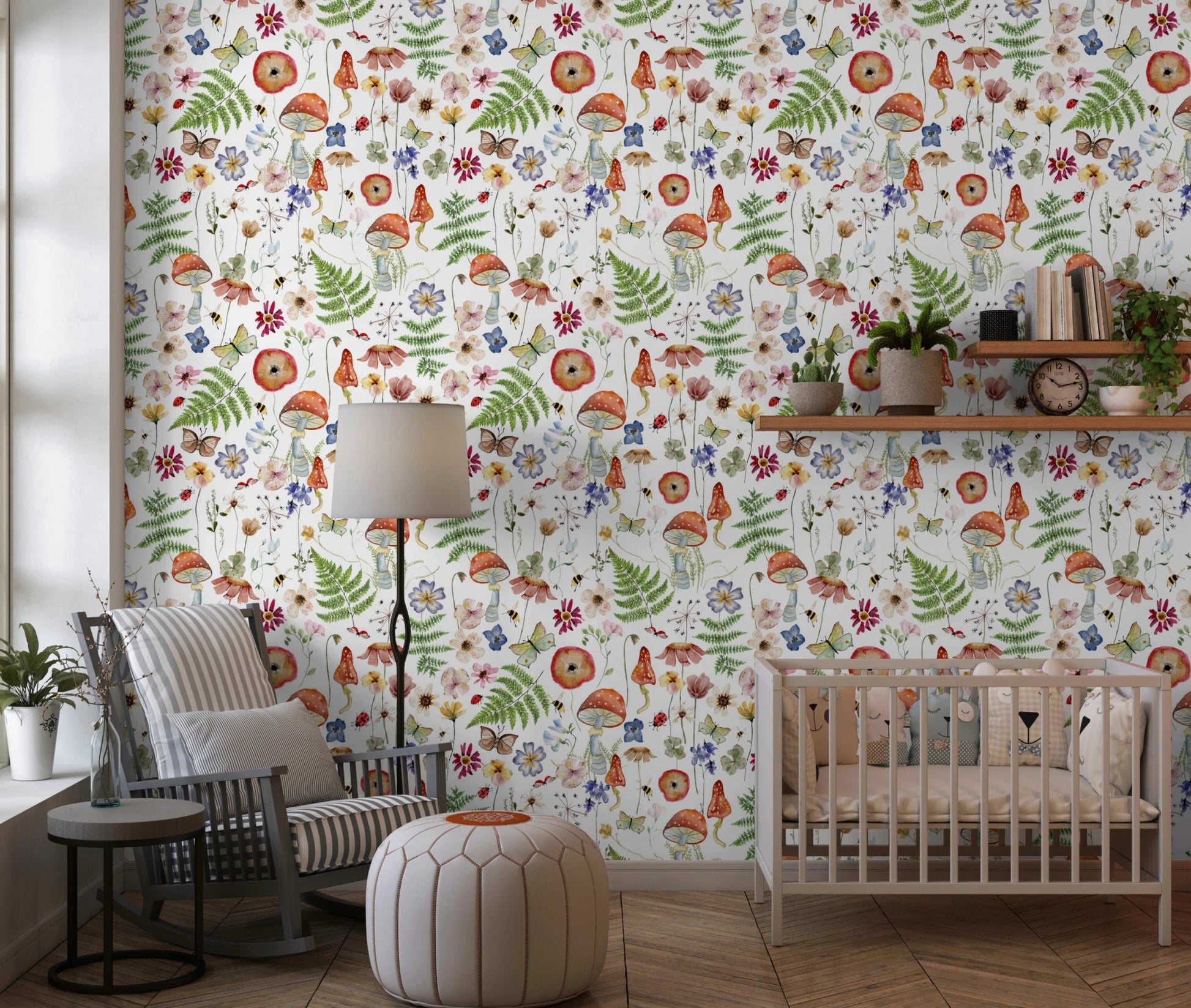 Whimsical Watercolor Meadow wallpaper mural in a nursery with a wooden crib, rattan rocker and leather pouf