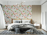 Whimsical Watercolor Meadow wallpaper mural behind a wood-headboard bed with grey bedding in a bright bedroom