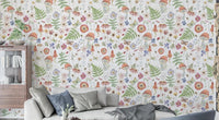 Whimsical Watercolor Meadow wallpaper mural in a living room with a beige sofa, blue cushions and wood cabinet