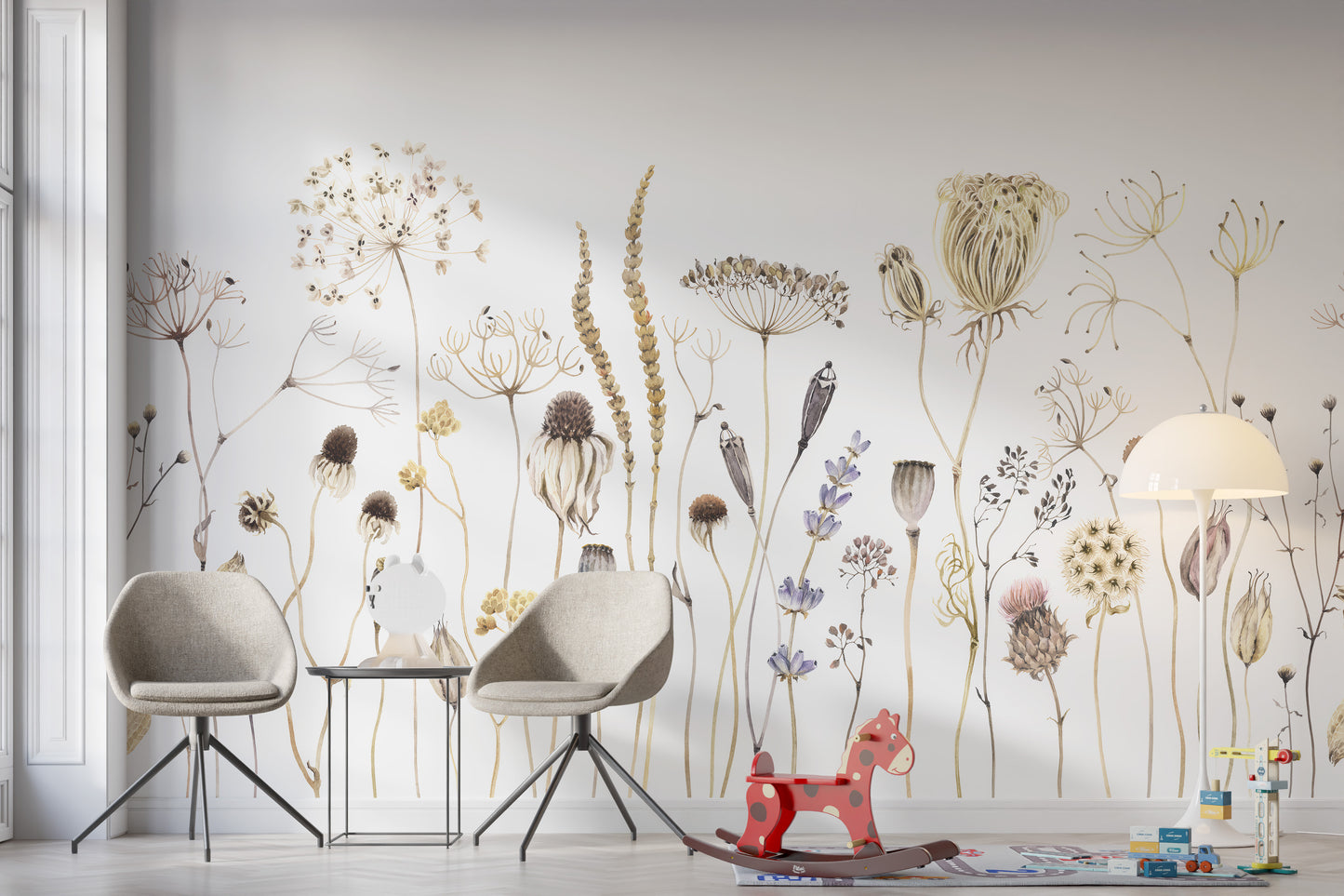 Whispering Meadows wallpaper mural of neutral dried blooms behind two grey chairs and a red rocking horse in a kids room