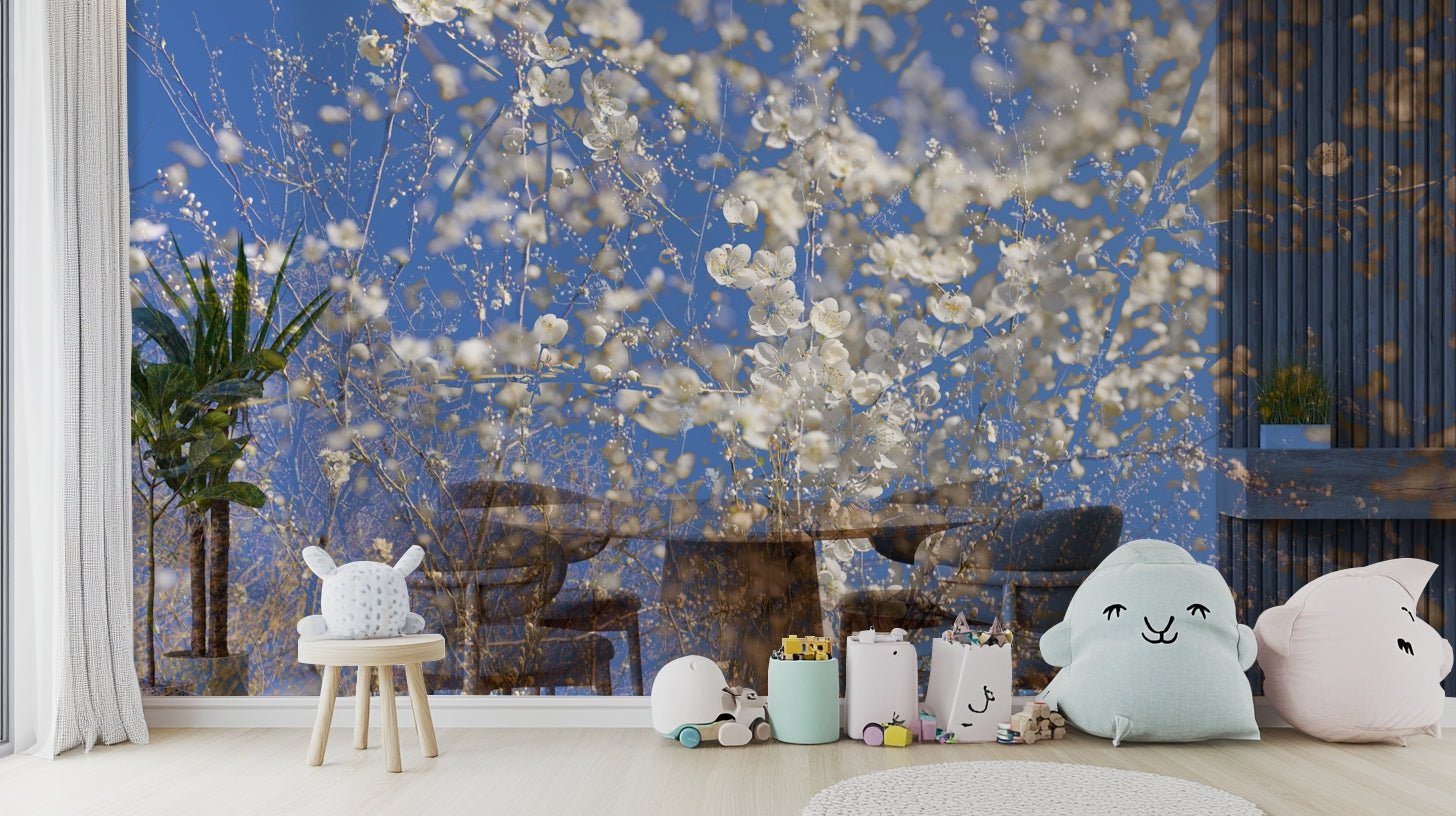 White Blossoms Against a Clear Blue Sky spring photography wall mural in a nursery with cloud pillows and toys along the floor