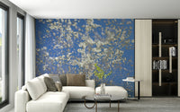 White Blossoms Against a Clear Blue Sky spring photography wall mural behind a white sectional in a modern living room with dark shelving