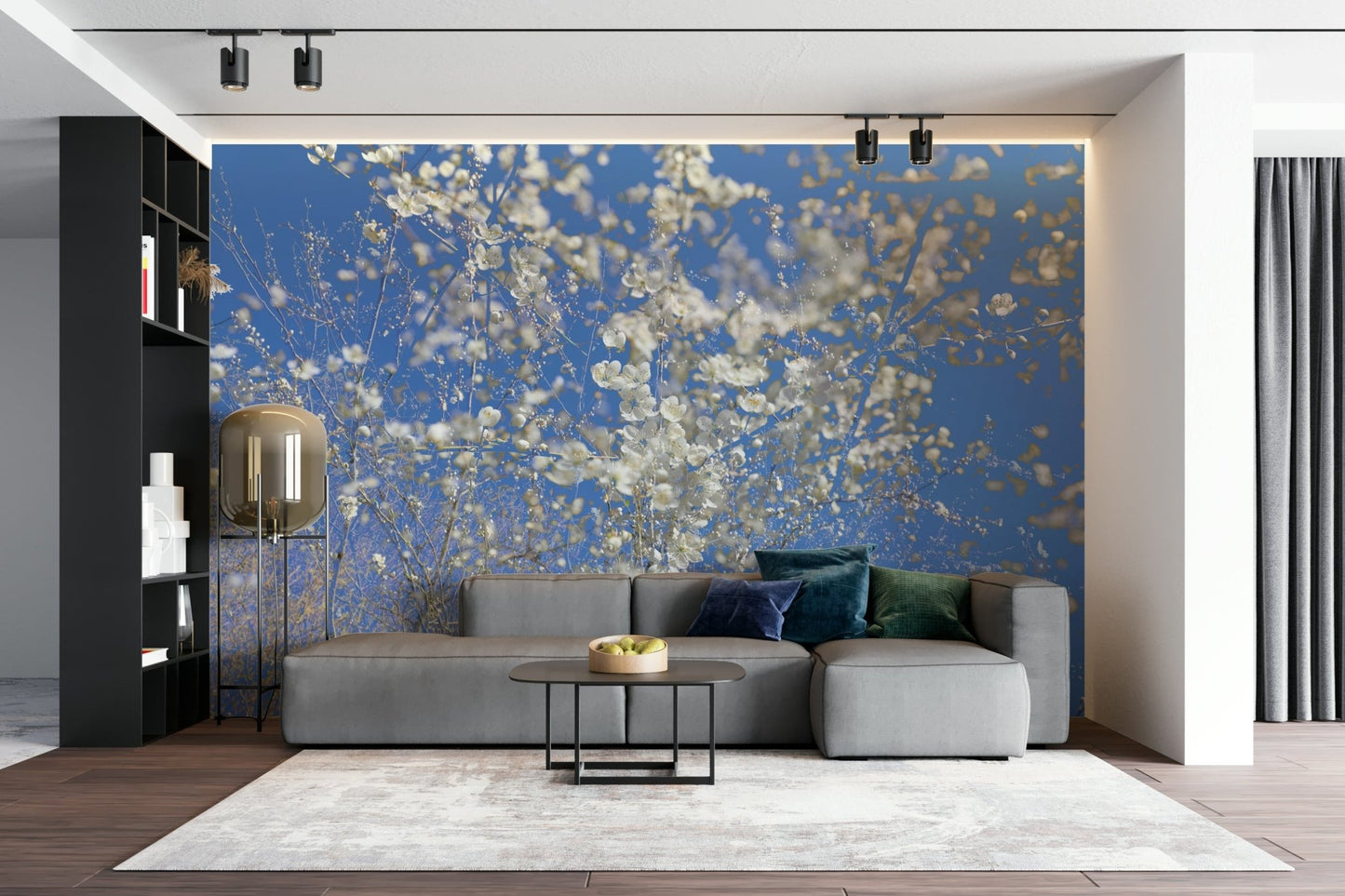 White Blossoms Against a Clear Blue Sky spring photography wall mural behind a gray modular sofa and gold floor lamp in a living room
